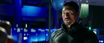 Movie still from “Teenage Mutant Ninja Turtles: Out of the Shadows” (2016), directed by Dave Green – A person wearing a suit; Close Up shot, Over the shoulder angle