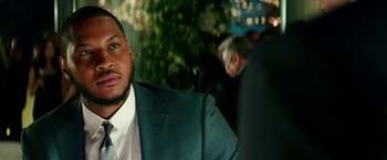 Movie still from “Teenage Mutant Ninja Turtles: Out of the Shadows” (2016), directed by Dave Green – A person wearing a suit and tie; Close Up shot, Over the shoulder angle