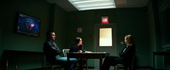 Movie still from “Teenage Mutant Ninja Turtles: Out of the Shadows” (2016), directed by Dave Green – A couple of people sitting at a table in a room; Wide shot, Over the shoulder angle