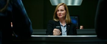 Movie still from “Teenage Mutant Ninja Turtles: Out of the Shadows” (2016), directed by Dave Green – A woman in a black jacket holding a cell phone; Close Up shot, Over the shoulder angle