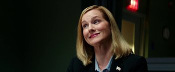 Movie still from “Teenage Mutant Ninja Turtles: Out of the Shadows” (2016), directed by Dave Green – A person wearing a suit and smiling; Close Up shot, Over the shoulder angle