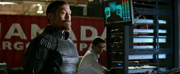 Movie still from “Teenage Mutant Ninja Turtles: Out of the Shadows” (2016), directed by Dave Green – A man with a beard is standing in front of a computer screen; Medium shot, Over the shoulder angle