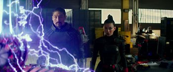 Movie still from “Teenage Mutant Ninja Turtles: Out of the Shadows” (2016), directed by Dave Green – A man and a woman standing next to each other; Medium shot, Over the shoulder angle