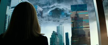 Movie still from “Teenage Mutant Ninja Turtles: Out of the Shadows” (2016), directed by Dave Green – A woman standing in front of a city skyline; Medium shot, Low angle