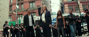 Movie still from “Teenage Mutant Ninja Turtles: Out of the Shadows” (2016), directed by Dave Green – A group of people standing on a street; Wide shot, Low angle