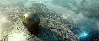 Movie still from “Teenage Mutant Ninja Turtles: Out of the Shadows” (2016), directed by Dave Green – An aerial view of a city with a globe on top of it; Extreme Wide shot, Overhead angle