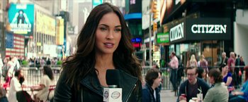 Movie still from “Teenage Mutant Ninja Turtles: Out of the Shadows” (2016), directed by Dave Green – A beautiful woman with long brown hair holding a coffee cup; Close Up shot, Over the shoulder angle