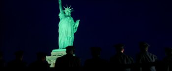 Movie still from “Teenage Mutant Ninja Turtles: Out of the Shadows” (2016), directed by Dave Green – A group of people standing in front of the statue of liberty; Extreme Wide shot, Low angle