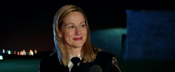 Movie still from “Teenage Mutant Ninja Turtles: Out of the Shadows” (2016), directed by Dave Green – A woman in a uniform smiling for the camera; Close Up shot, Over the shoulder angle
