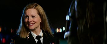 Movie still from “Teenage Mutant Ninja Turtles: Out of the Shadows” (2016), directed by Dave Green – A woman in a uniform smiling for the camera; Close Up shot, Over the shoulder angle