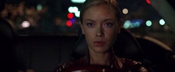 Movie still from “Terminator 3: Rise of the Machines” (2003), directed by Jonathan Mostow – A beautiful woman with blue eyes looking at the camera; Close Up shot, Over the shoulder angle