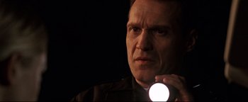 Movie still from “Terminator 3: Rise of the Machines” (2003), directed by Jonathan Mostow – A person holding a flashlight; Close Up shot, Low angle