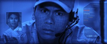 Movie still from “Terminator 3: Rise of the Machines” (2003), directed by Jonathan Mostow – A man wearing a hat and a headset; Extreme Close Up shot, Overhead angle