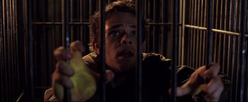 Movie still from “Terminator 3: Rise of the Machines” (2003), directed by Jonathan Mostow – A man in a jail cell with his eyes wide open; Close Up shot, Overhead angle