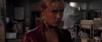 Movie still from “Terminator 3: Rise of the Machines” (2003), directed by Jonathan Mostow – A woman in a leather jacket looking at the camera; Close Up shot, Over the shoulder angle