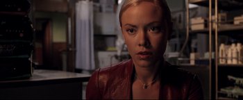 Movie still from “Terminator 3: Rise of the Machines” (2003), directed by Jonathan Mostow – A woman in a red leather jacket looking at the camera; Close Up shot, Over the shoulder angle