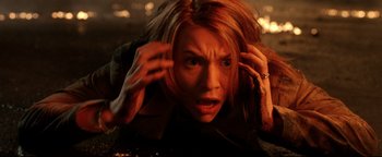 Movie still from “Terminator 3: Rise of the Machines” (2003), directed by Jonathan Mostow – A woman with her hands on her head; Close Up shot, High angle