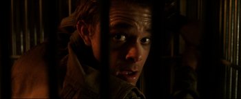 Movie still from “Terminator 3: Rise of the Machines” (2003), directed by Jonathan Mostow – A person behind a fence; Extreme Close Up shot, Overhead angle