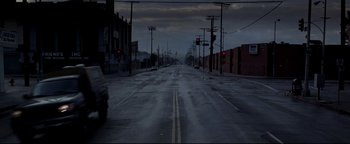 Movie still from “Terminator 3: Rise of the Machines” (2003), directed by Jonathan Mostow – An empty street at night with a red traffic light; Extreme Wide shot, High angle
