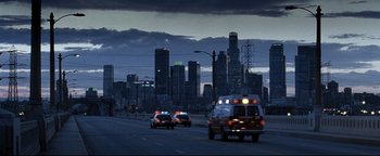 Movie still from “Terminator 3: Rise of the Machines” (2003), directed by Jonathan Mostow – A group of emergency vehicles driving down a street; Extreme Wide shot, High angle