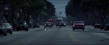 Movie still from “Terminator 3: Rise of the Machines” (2003), directed by Jonathan Mostow – A street scene with cars driving down the road; Extreme Wide shot, High angle