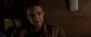 Movie still from “Terminator 3: Rise of the Machines” (2003), directed by Jonathan Mostow – A person wearing a jacket; Close Up shot, Over the shoulder angle