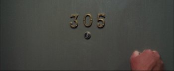 Movie still from “Terminator 3: Rise of the Machines” (2003), directed by Jonathan Mostow – The number 3 0 5 on a door; Extreme Close Up shot, Overhead angle