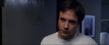 Movie still from “Terminator 3: Rise of the Machines” (2003), directed by Jonathan Mostow – A person wearing a white t - shirt; Close Up shot, High angle
