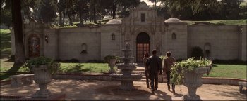 Movie still from “Terminator 3: Rise of the Machines” (2003), directed by Jonathan Mostow – A group of people walking in front of a fountain; Wide shot, High angle
