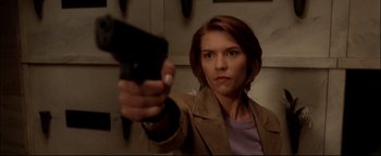 Movie still from “Terminator 3: Rise of the Machines” (2003), directed by Jonathan Mostow – A woman is holding a cell phone in her hand; Close Up shot, Low angle