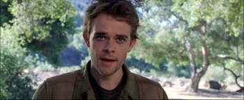 Movie still from “Terminator 3: Rise of the Machines” (2003), directed by Jonathan Mostow – A person wearing a brown jacket; Close Up shot, Over the shoulder angle