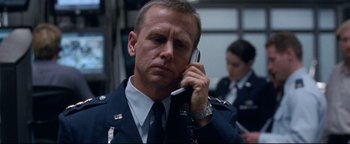 Movie still from “Terminator 3: Rise of the Machines” (2003), directed by Jonathan Mostow – A man in uniform talking on a cell phone; Close Up shot, Low angle