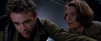 Movie still from “Terminator 3: Rise of the Machines” (2003), directed by Jonathan Mostow – A man and a woman are sitting together; Close Up shot, Low angle