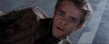 Movie still from “Terminator 3: Rise of the Machines” (2003), directed by Jonathan Mostow – A person with blood on his face; Close Up shot, Overhead angle