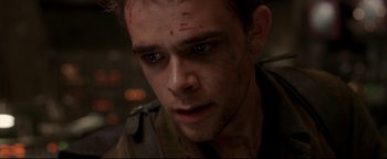 Movie still from “Terminator 3: Rise of the Machines” (2003), directed by Jonathan Mostow – A person with a knife on his face; Close Up shot, Low angle