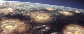 Movie still from “Terminator 3: Rise of the Machines” (2003), directed by Jonathan Mostow – An image of an asteroid in the middle of the sky; Extreme Wide shot, Overhead angle