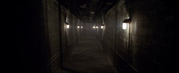 Movie still from “Terminator 3: Rise of the Machines” (2003), directed by Jonathan Mostow – A dark hallway with lights on the walls; Extreme Wide shot, High angle