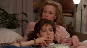 Movie still from “Terms of Endearment” (1983), directed by James L. Brooks – A woman sitting next to another woman on a bed; Close Up shot, Over the shoulder angle