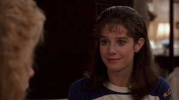 Movie still from “Terms of Endearment” (1983), directed by James L. Brooks – A young woman is smiling for the camera; Close Up shot, Over the shoulder angle