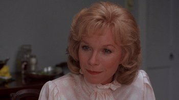 Movie still from “Terms of Endearment” (1983), directed by James L. Brooks – An older woman with blonde hair wearing a pink shirt; Close Up shot, Low angle