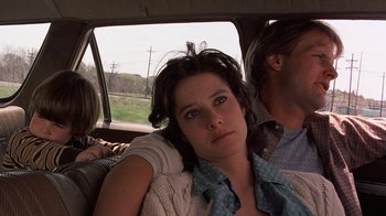 Movie still from “Terms of Endearment” (1983), directed by James L. Brooks – A woman sitting in the back seat of a car; Close Up shot, Over the shoulder angle