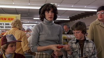 Movie still from “Terms of Endearment” (1983), directed by James L. Brooks – A woman holding a pair of scissors in her hands; Medium shot, Low angle