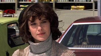 Movie still from “Terms of Endearment” (1983), directed by James L. Brooks – A young woman with brown curly hair wearing a sweater; Close Up shot, Low angle