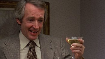 Movie still from “Terms of Endearment” (1983), directed by James L. Brooks – An older man holding a glass of white wine; Close Up shot, Over the shoulder angle