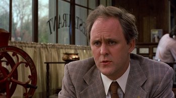 Movie still from “Terms of Endearment” (1983), directed by James L. Brooks – A person wearing a suit and tie; Close Up shot, Over the shoulder angle