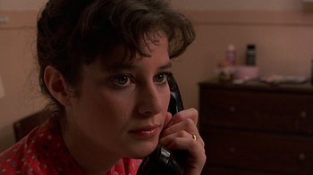 Movie still from “Terms of Endearment” (1983), directed by James L. Brooks – A person talking on a phone; Close Up shot, Low angle