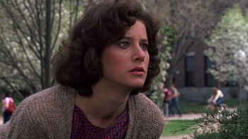 Movie still from “Terms of Endearment” (1983), directed by James L. Brooks – A young woman with brown curly hair looking to her left; Close Up shot, Low angle