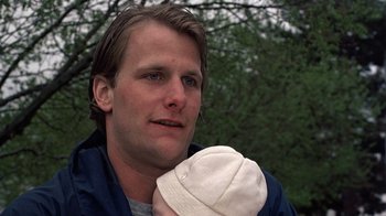 Movie still from “Terms of Endearment” (1983), directed by James L. Brooks – A man holding a baby in his arms; Close Up shot, Low angle