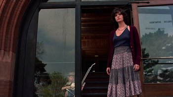 Movie still from “Terms of Endearment” (1983), directed by James L. Brooks – A woman standing in front of an open front door; Medium shot, Low angle
