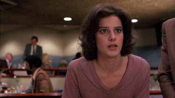 Movie still from “Terms of Endearment” (1983), directed by James L. Brooks – A young woman is sitting at a table in front of a group of people; Close Up shot, Low angle